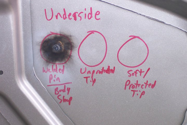 A white car door with some red writing on it