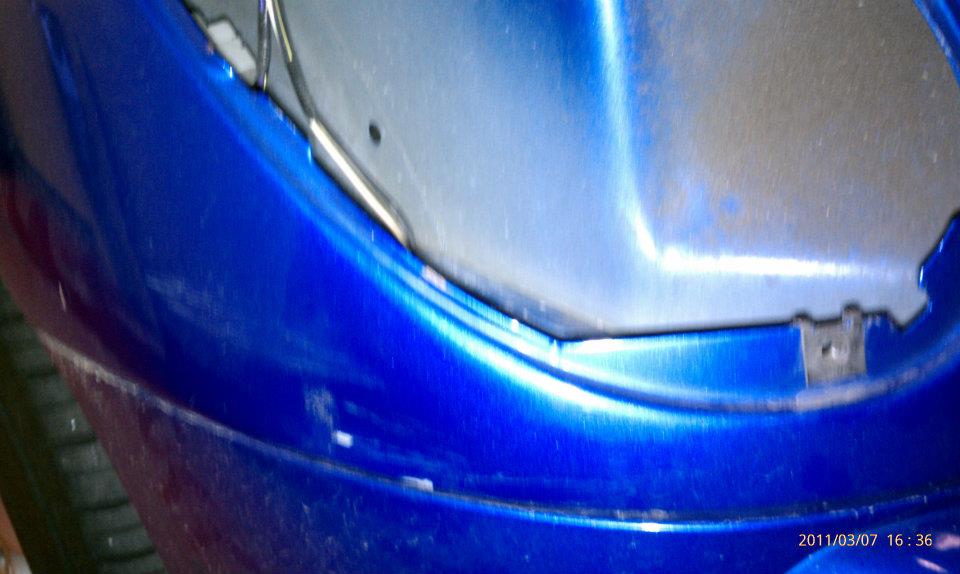 A close up of the side of a blue car.