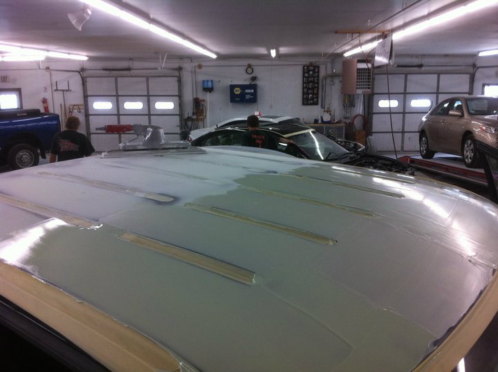 A car is being worked on in the shop.