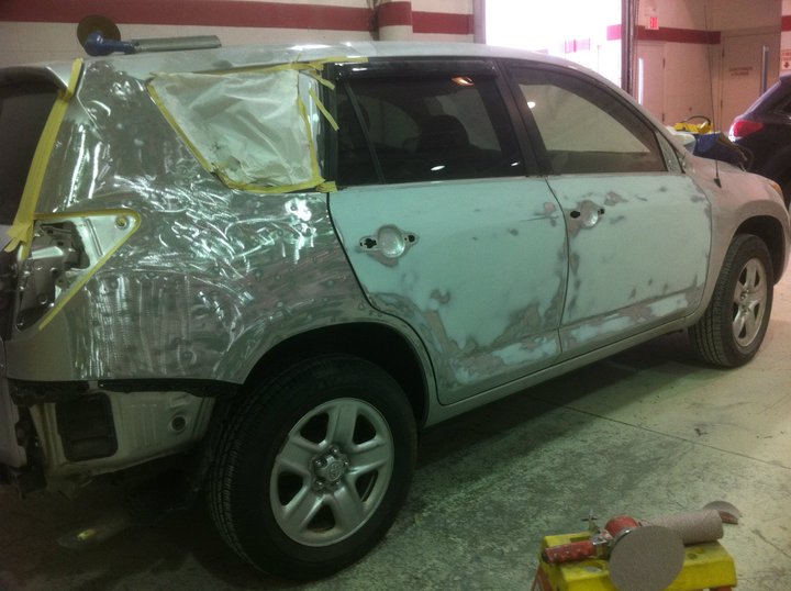 A car that is covered in foil and has been painted.