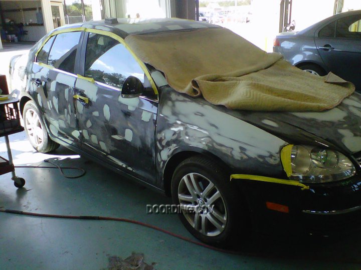 A car that is covered in paint and has been painted.