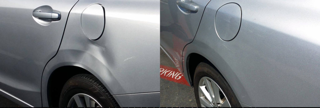 A car with dents and scratches on the side of it.