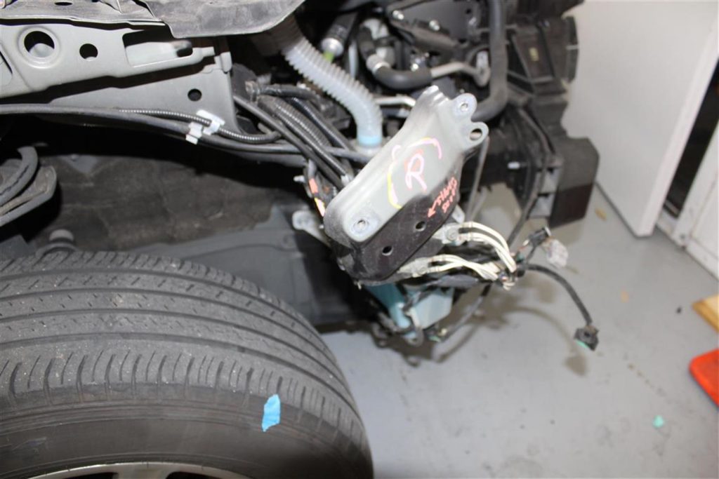 A car that has been broken down and is in the process of being repaired.