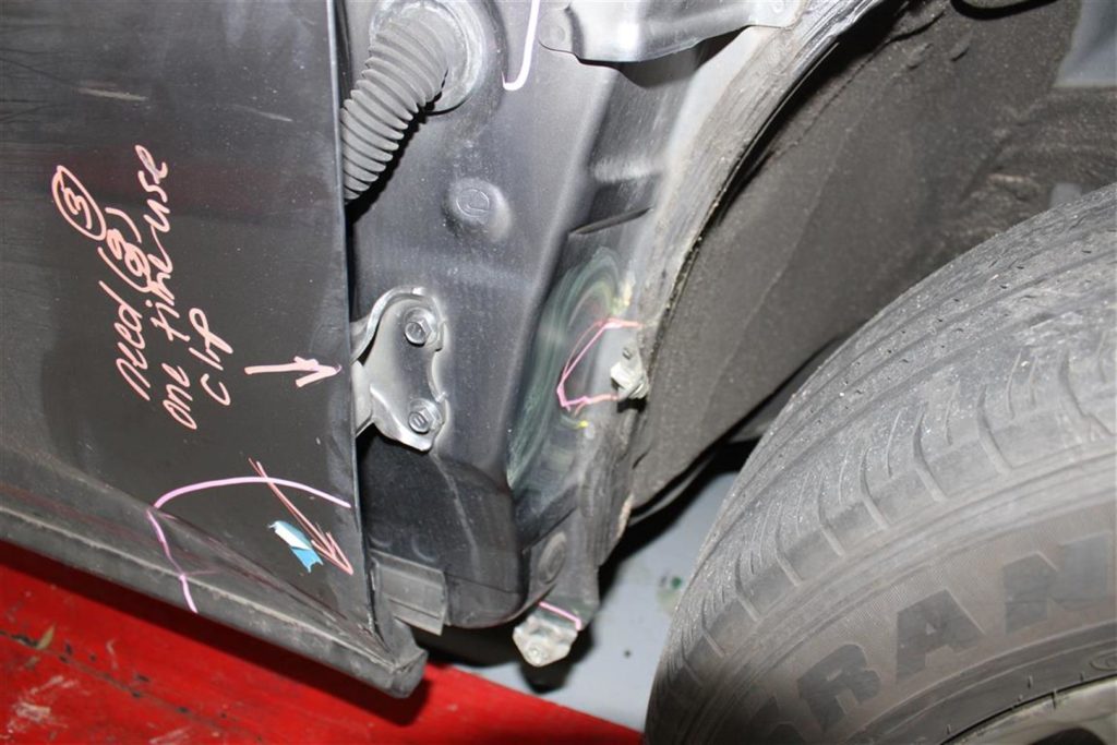 A car that has been bent over and is in the process of being repaired.
