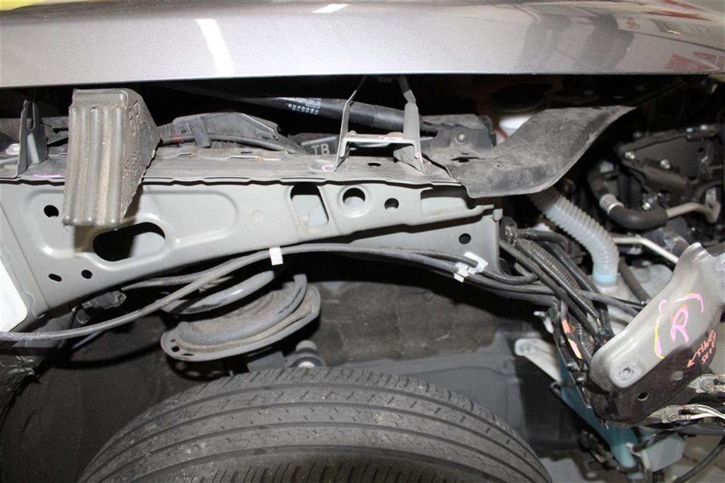 A car that has been broken down and is in the process of being repaired.