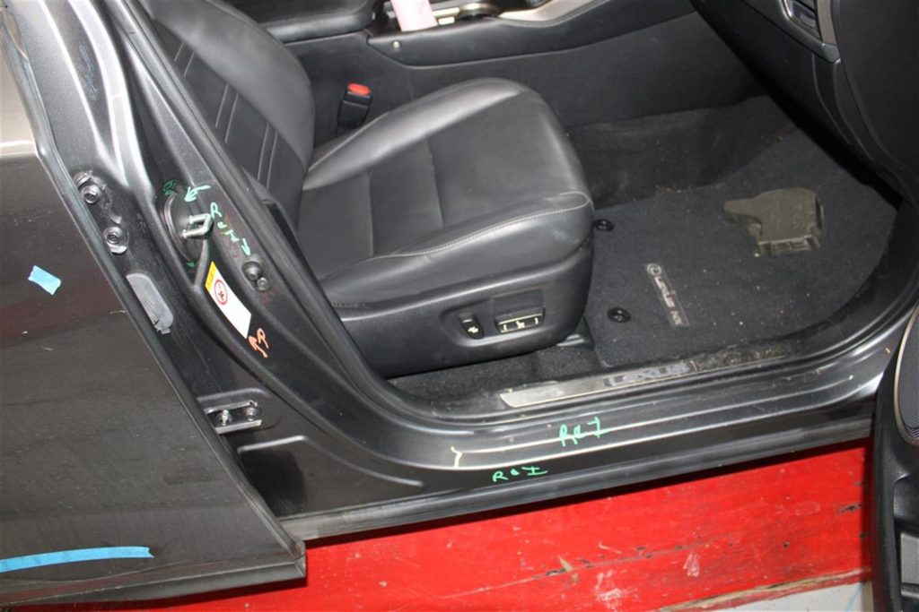 A car door with the seat removed.