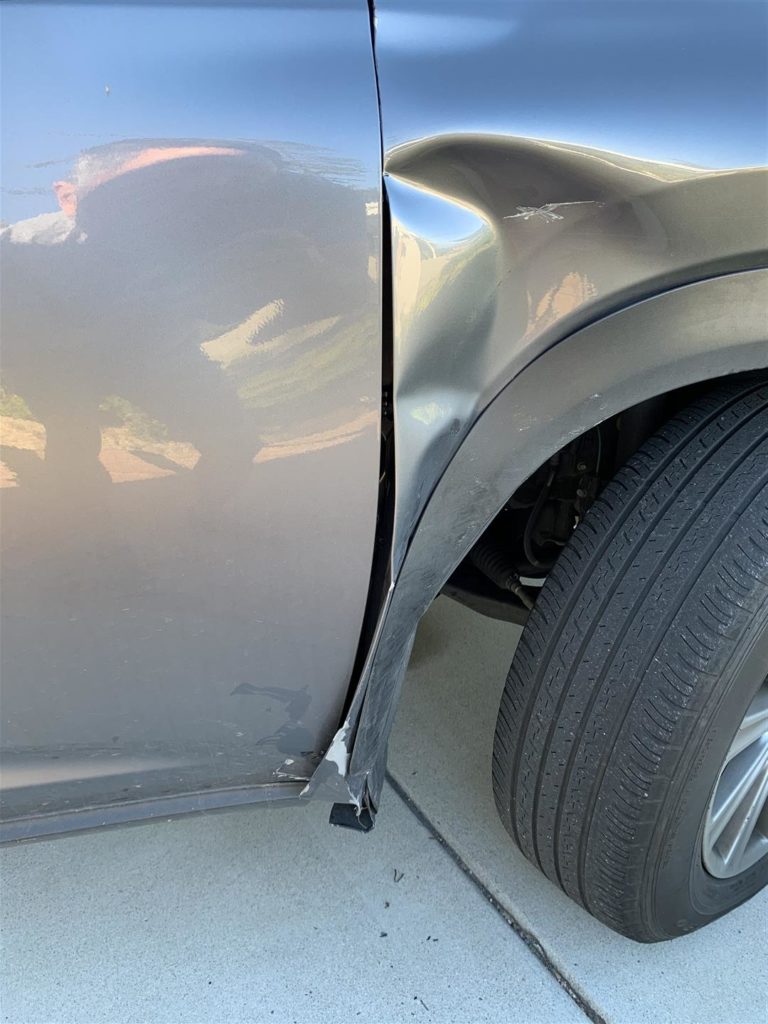 A car that has been hit by an oncoming vehicle.