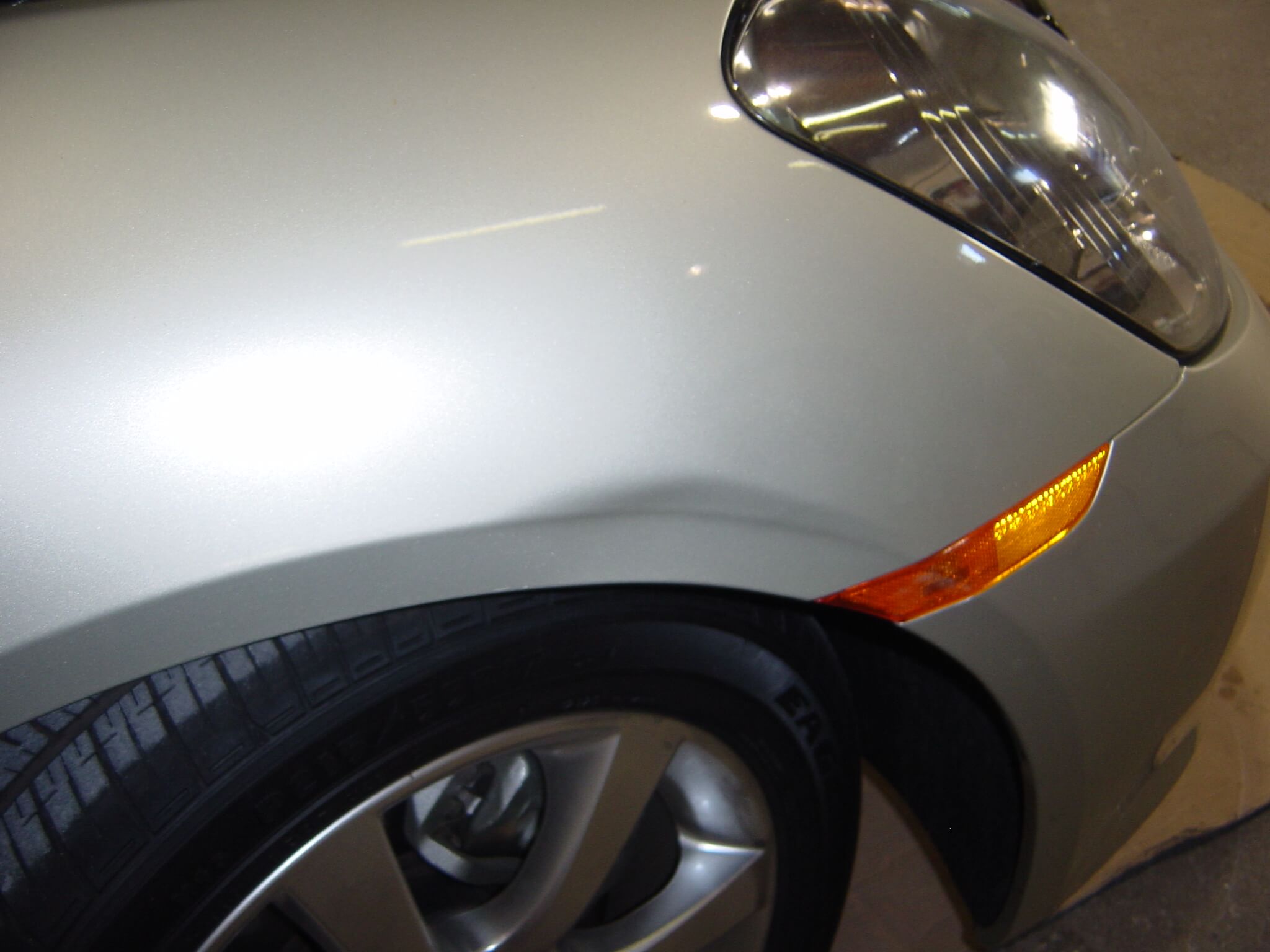 A close up of the front tire on a car.