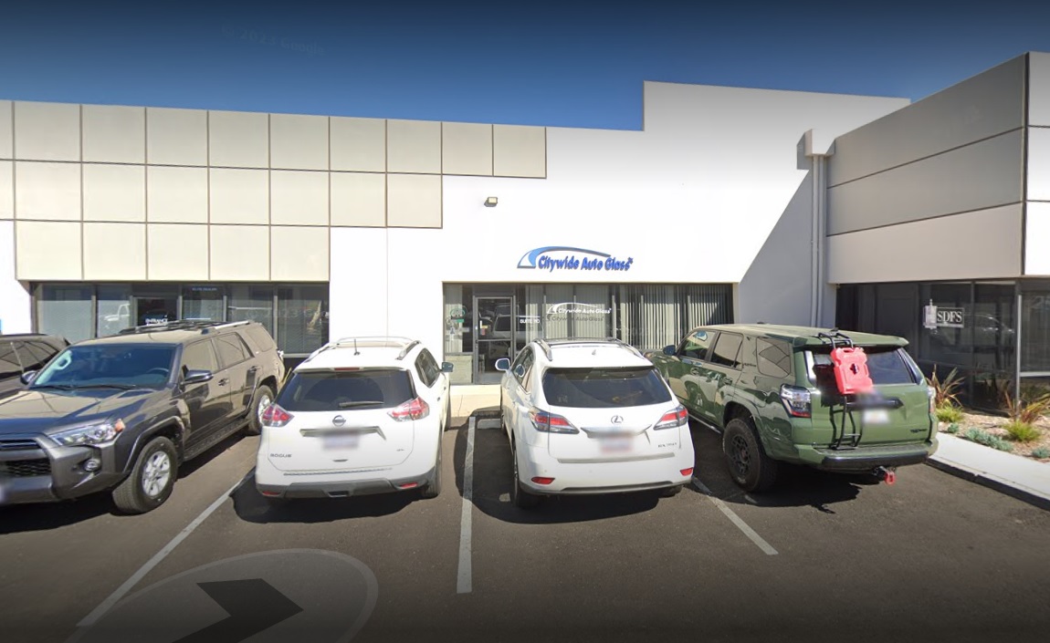 A couple of cars parked in front of a building.